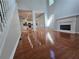 Open-concept living room with hardwood floors, fireplace, and seamless transition into the well-lit kitchen at 3773 Summer Rose Dr, Atlanta, GA 30341