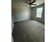 Neutral bedroom with a ceiling fan, window, and plush carpeting at 4297 Azalea Ridge Way, Hoschton, GA 30548