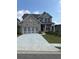 Charming two-story home with brick exterior, a large driveway, and well-manicured lawn at 4297 Azalea Ridge Way, Hoschton, GA 30548