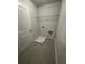 Practical laundry area with tile flooring and storage shelf at 4297 Azalea Ridge Way, Hoschton, GA 30548