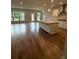 Open concept kitchen and living area with hardwood floors, lots of light and island seating at 4297 Azalea Ridge Way, Hoschton, GA 30548