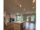 Spacious living room featuring a fireplace, large windows, and an open layout at 4297 Azalea Ridge Way, Hoschton, GA 30548
