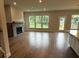 Spacious living room with hardwood floors, fireplace, and abundant natural light at 4297 Azalea Ridge Way, Hoschton, GA 30548