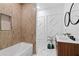 Modern bathroom featuring a double vanity, stylish fixtures, and tiled walls at 980 Porter Rd, Decatur, GA 30032