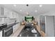 Bright, open kitchen with island, stainless appliances, and views into the living area at 980 Porter Rd, Decatur, GA 30032