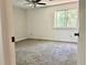 Cozy bedroom with neutral carpeting, a ceiling fan, and a window that allows for plenty of natural light at 1040 Forest East Dr, Stone Mountain, GA 30088