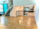 Open floor plan showcasing hardwood floors with kitchen view and a staircase leading to the upper level at 1040 Forest East Dr, Stone Mountain, GA 30088