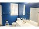 Full bathroom featuring blue walls, window, white sink, toilet and tiled shower at 2886 Thornbriar Rd, Atlanta, GA 30340