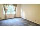 Bedroom with neutral walls, blue carpet, and window with curtains allowing natural light at 2886 Thornbriar Rd, Atlanta, GA 30340