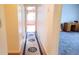 Hallway with wood floors and a rug leading to a room with carpet and a desk with drawers at 2886 Thornbriar Rd, Atlanta, GA 30340