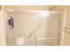 Shower with sliding glass doors and tiled walls, equipped with a shower head and towel rack at 2886 Thornbriar Rd, Atlanta, GA 30340