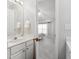 Bathroom leading to the bedroom with white cabinets and framed mirror at 3182 Mill Springs Cir, Buford, GA 30519