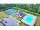 Aerial view of the community clubhouse, pool, and tennis courts offering a variety of leisure options at 5215 Wheeler Run Dr, Auburn, GA 30011