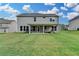 Spacious backyard offering a covered patio and ample green space for outdoor activities and entertaining at 5215 Wheeler Run Dr, Auburn, GA 30011