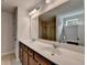 Elegant bathroom with double vanities, a large mirror, and modern lighting fixtures at 5215 Wheeler Run Dr, Auburn, GA 30011