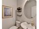 Cozy half-bath with a pedestal sink and decorative wall art at 5215 Wheeler Run Dr, Auburn, GA 30011