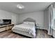Inviting bedroom showcasing lots of natural light, neutral walls, a comfortable bed, and a mounted television at 5215 Wheeler Run Dr, Auburn, GA 30011