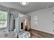 Bright and airy bedroom with a custom playhouse bed, ball pit and stylish gray wood flooring at 5215 Wheeler Run Dr, Auburn, GA 30011