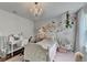 Well-decorated bedroom with a hanging chair, chandelier, and a desk area, perfect for a  at 5215 Wheeler Run Dr, Auburn, GA 30011