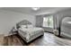 Inviting bedroom features a comfortable bed, ample natural light, and modern decor at 5215 Wheeler Run Dr, Auburn, GA 30011