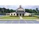 Community clubhouse featuring a modern design, ample parking, and well-manicured landscaping at 5215 Wheeler Run Dr, Auburn, GA 30011