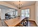 Open concept dining room featuring a long table and hardwood floors at 5215 Wheeler Run Dr, Auburn, GA 30011