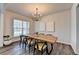 Stylish dining room with a wooden table, hardwood floors, and a window at 5215 Wheeler Run Dr, Auburn, GA 30011