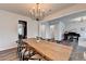 Open concept dining room with a long wooden table and views of living area at 5215 Wheeler Run Dr, Auburn, GA 30011