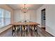 Elegant dining room with modern chandelier and hardwood floors at 5215 Wheeler Run Dr, Auburn, GA 30011