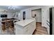Bright open kitchen and dining area with a large island, stainless appliances, and wood flooring at 5215 Wheeler Run Dr, Auburn, GA 30011