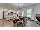 Bright kitchen with white cabinets, stainless steel appliances, and an island with bar stool seating at 5215 Wheeler Run Dr, Auburn, GA 30011
