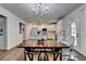 Bright kitchen with white cabinets and countertops with stainless steel appliances and wood flooring at 5215 Wheeler Run Dr, Auburn, GA 30011