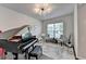 This living room features a baby grand piano, a modern ceiling fan and a large window at 5215 Wheeler Run Dr, Auburn, GA 30011