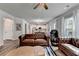 This spacious living room is furnished with leather sofas and connects to a kitchen area at 5215 Wheeler Run Dr, Auburn, GA 30011