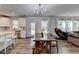 Open concept living area featuring wood floors, a modern chandelier, and ample natural light at 5215 Wheeler Run Dr, Auburn, GA 30011
