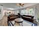 This spacious living room is furnished with leather sofas and connects to a kitchen at 5215 Wheeler Run Dr, Auburn, GA 30011