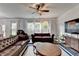 This spacious living room is furnished with leather sofas and features large windows at 5215 Wheeler Run Dr, Auburn, GA 30011