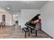 The living room features a baby grand piano and flows into other spaces at 5215 Wheeler Run Dr, Auburn, GA 30011