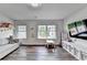 Playroom features a comfortable couch, natural light and a tv for entertainment at 5215 Wheeler Run Dr, Auburn, GA 30011