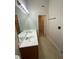 Bathroom featuring double sink vanity and walk-in closet at 6941 Rogers Pt, Lithonia, GA 30058