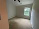 This bedroom has carpet, neutral walls, and a window at 6941 Rogers Pt, Lithonia, GA 30058