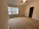 Bedroom featuring carpeted floors and a large window for ample natural light at 6941 Rogers Pt, Lithonia, GA 30058