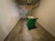 One car garage features concrete floors and walls and a green waste container at 6941 Rogers Pt, Lithonia, GA 30058