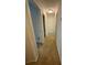 The upstairs hallway has neutral carpeting and lighting with access to other rooms at 6941 Rogers Pt, Lithonia, GA 30058