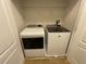 Laundry closet with side-by-side washer and dryer, and white wire shelving at 6941 Rogers Pt, Lithonia, GA 30058