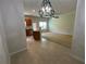 View from living room into kitchen and nook area featuring neutral wall colors and updated appliances at 6941 Rogers Pt, Lithonia, GA 30058