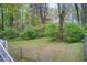 Spacious backyard with green grass and surrounding trees, offering a natural setting at 2293 Ewing Sw St, Atlanta, GA 30331