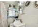 Modest bathroom with a vanity, toilet, patterned shower curtain, and wall decorations at 2293 Ewing Sw St, Atlanta, GA 30331