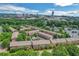 Aerial view of townhome community surrounded by lush greenery, with a cityscape in the distance at 2548 Crescent Park Ct # 7, Atlanta, GA 30339