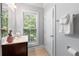Well-lit bathroom with a white vanity and window with a wooded view at 2548 Crescent Park Ct # 7, Atlanta, GA 30339